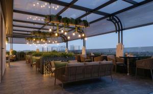 a rooftop restaurant with a view of a city at La Passion Elegance Hotel & Spa in Hanoi