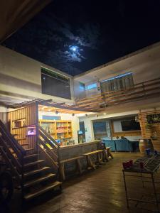 a restaurant with a bar with a moonlit ceiling at Shambala Hostel in Huacachina