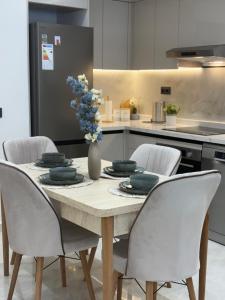 a dining room table with chairs and a vase of flowers at Riviera garden 9 in Cabo Negro
