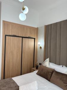 a bedroom with a bed with a wooden wall at Riviera garden 9 in Cabo Negro +21 photos