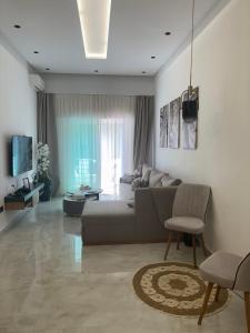 a living room with a couch and a tv at Riviera garden 9 in Cabo Negro