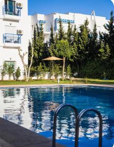 a swimming pool in front of a building at Riviera garden 9 in Cabo Negro