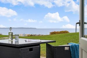 a patio with a table and a view of the ocean at Sct Knudsborg - 12C - Apartment on the beach in Brenderup