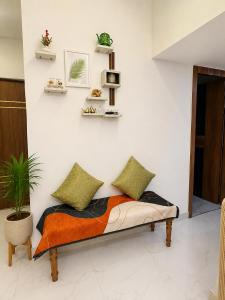 a bed with two pillows on it in a room at Riwaayat & Wings, a luxe stay 5 min from Taj Mahal in Tājganj
