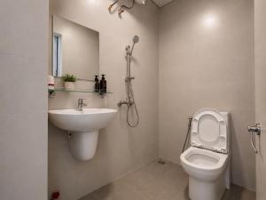 a bathroom with a toilet and a sink at 1 House 2 in Da Lat