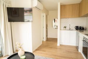 a kitchen with white cabinets and a table in a room at Southern Peaks Hideaway in Queenstown Airport +15 photos