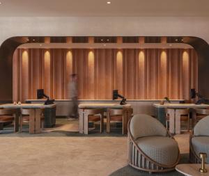 a lobby with tables and chairs and a man in the background at Avani Mooloolaba Beach Hotel in Mooloolaba +60 photos