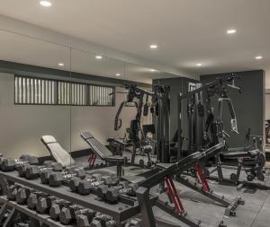 a gym with a lot of treadmills and machines at Avani Mooloolaba Beach Hotel in Mooloolaba