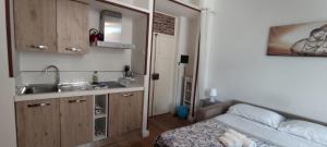 a small kitchen with a sink and a bed in a room at Agropoli loft 23 in Agropoli +4 photos