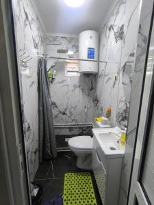 a small bathroom with a toilet and a sink at Амир in Arkit +16 photos