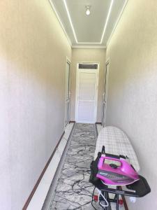 a room with a purple treadmill in a room with a door at Амир in Arkit