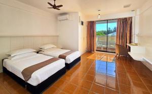 a hotel room with two beds and a desk at Rashu Hiyaa Hotel in Dhiffushi +113 photos