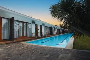 a swimming pool in front of a building at Pebble & Fins Bali Dive Resort in Tulamben