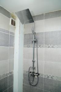 a shower with a shower head in a bathroom at Winner house in Oran +30 photos