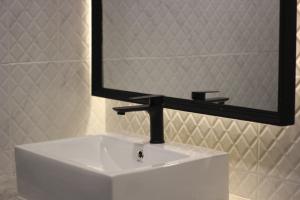 a bathroom sink with a large mirror above it at Hotel De Kiang Muang in Chiang Mai +32 photos