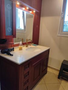 a bathroom with a sink and a mirror at Sunshine in Skala Marion +40 photos