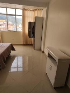a bedroom with a bed and a tv in a room at Habitación completa in Huaraz