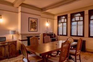 a dining room with a table and a fireplace at Fothergill House - Entire Luxury Townhouse - City Centre in Nottingham