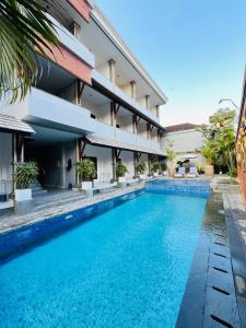 an image of a swimming pool in front of a building at Jesens Inn II in Kuta