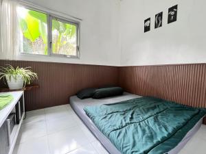 a bed in a room with a window at SleepOver BDI2 in Wonosobo