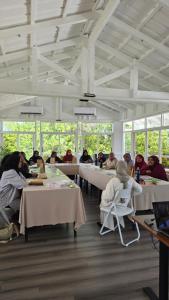 a group of people sitting at tables in a room at Rashu Hiyaa Hotel in Dhiffushi