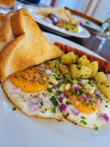 a white plate with eggs and toast and potatoes at Esmin's Homestay - Women Only in Hatton +21 photos