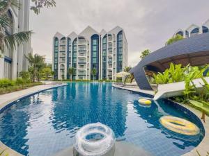 a large swimming pool in front of a building at Title Naiyang Walk To Beach C111 in Nai Yang Beach