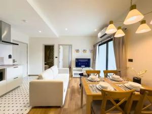 a living room with a white couch and a table at Title Naiyang Walk To Beach C111 in Nai Yang Beach