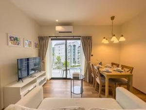 a living room with a table and a dining room at Title Naiyang Walk To Beach C111 in Nai Yang Beach