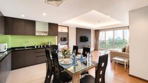 a kitchen and dining room with a table and chairs at Olive Hotel & Residence Bangkok Sukhumvit 101 near True Digital Park in Bangkok