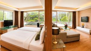 a bedroom with a large bed and a large window at Olive Hotel & Residence Bangkok Sukhumvit 101 near True Digital Park in Bangkok