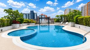 a large swimming pool on top of a building at Olive Hotel & Residence Bangkok Sukhumvit 101 near True Digital Park in Bangkok