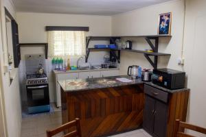 a kitchen with a stove and a counter top at Tanuli Heights in Honiara