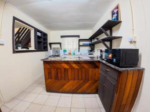 a kitchen with a counter with a microwave at Tanuli Heights in Honiara