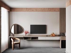 a living room with a tv and a mirror at Urban Hotel Ethno in Bishkek
