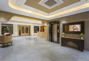 a lobby with a fireplace in a building at Tripli Regalia Mayur Palace in Udaipur +109 photos