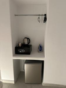 a kitchen with a counter with a toaster on a shelf at Eternal Town in Mikonos