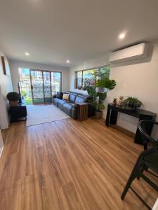 a living room with a couch and wooden floors at Surfers 641 in Gold Coast