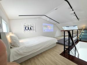a small bedroom with a bed and a staircase at Liverpool & Spa in Jeju +145 photos