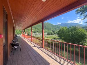 a balcony with a view of the mountains at Hotel Mirioni in Oni