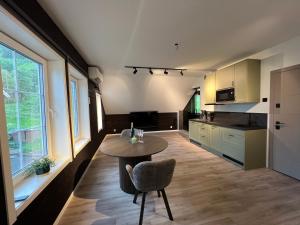 a kitchen with a table and a chair in a room at Jolster SPA apartments for 2 in Skei