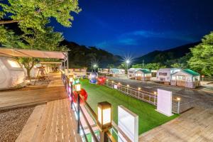 a view of a village at night with lights at Jirisan Forest Caravan Park in Gurye