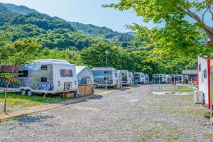 a row of rvs parked in a parking lot at Jirisan Forest Caravan Park in Gurye