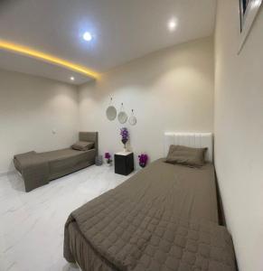 a bedroom with a large bed and a couch at Green Stays in Comilla