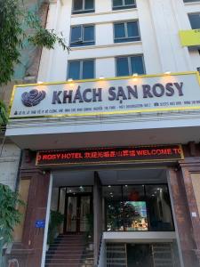 a building with a sign for a sushi restaurant at Khách sạn Rosy in Hòa Ðình