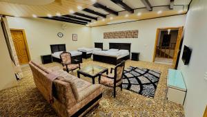 a living room with a couch and a table at Highland Lodges Balakot in Bālākot