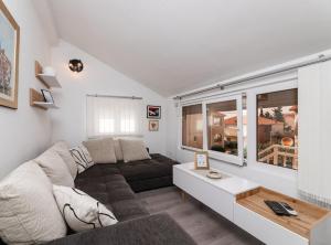 a living room with a couch and a table at Apartments Roda in Supetar +11 photos
