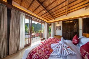 a bedroom with a bed and a large window at Kropak Sidemen in Sidemen +55 photos