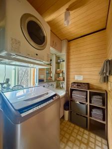 a kitchen with a sink and a stove top oven at Takumisou 2 in Kiso