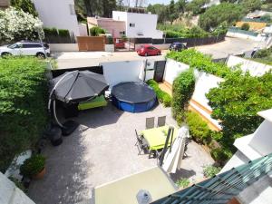 an overhead view of a patio with an umbrella and a grill at El Madroño de la Encantada in Córdoba